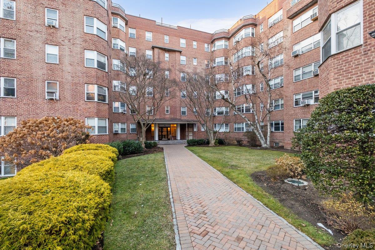 235 Garth Road, Unit E2A Scarsdale, NY 10583 - Photo 33 of 37 a view of a building with a garden