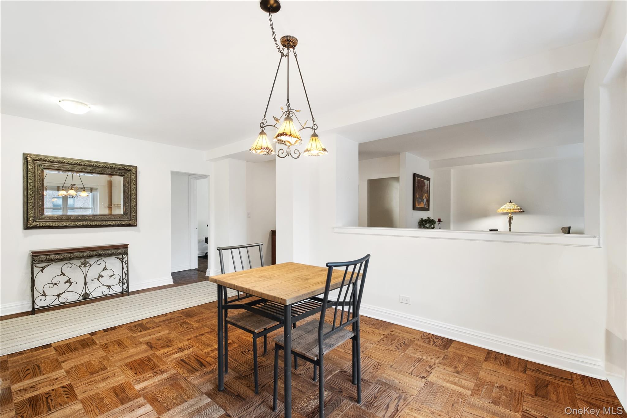 235 Garth Road, Unit E2A Scarsdale, NY 10583 - Photo 10 of 37 a view of a dining room with furniture and wooden floor