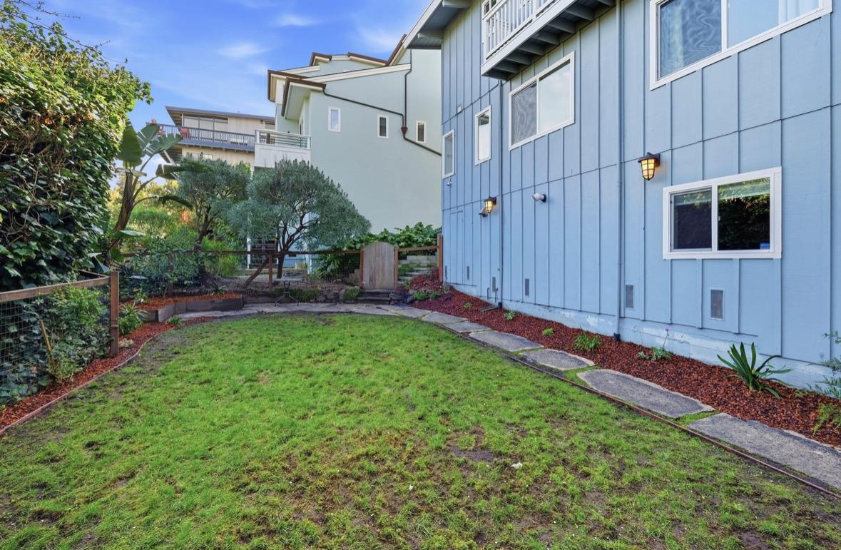 229 Rio Del Mar Boulevard Aptos, CA 95003 - Photo 27 of 27 a backyard of a house with plants and a tree