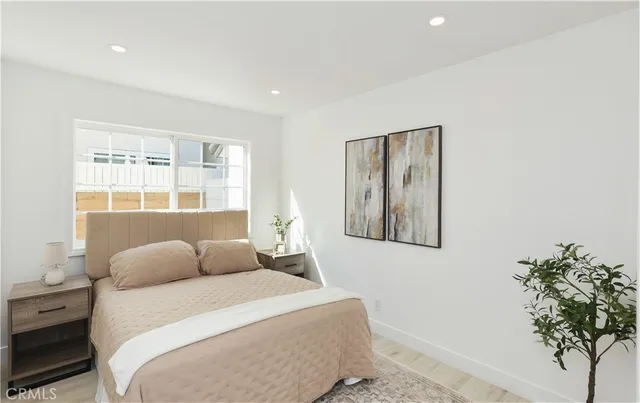 a bedroom with a bed and a window