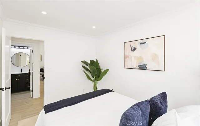 a bedroom with a bed and a painting on the wall