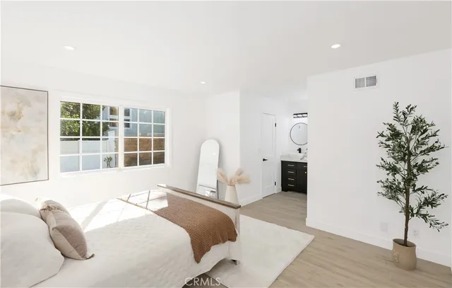 a bedroom with a bed and a large window