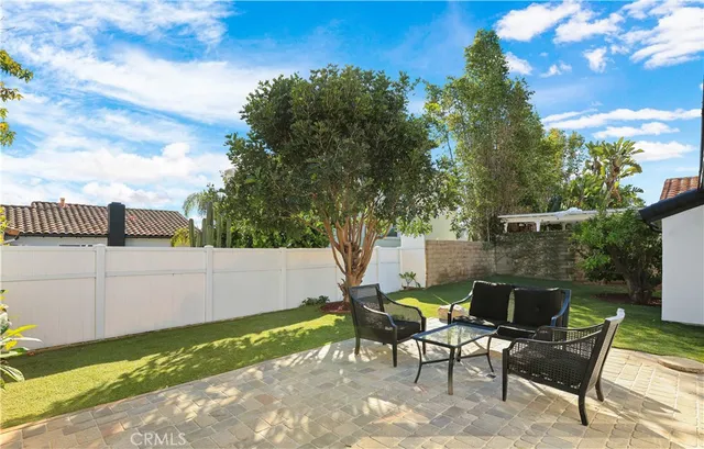 a view of a backyard with sitting area