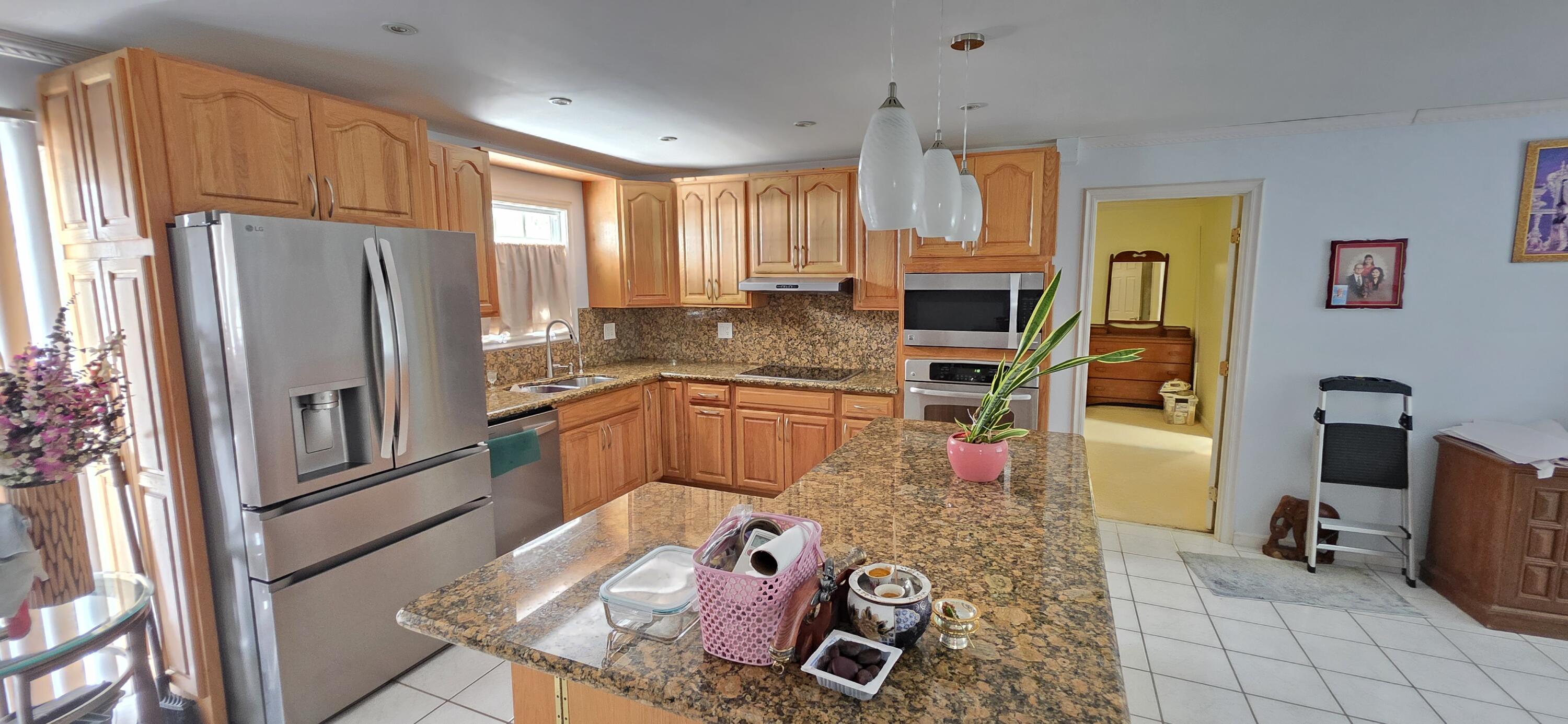 8 Emerald Drive Key West, FL 33040 - Photo 12 of 43 a kitchen with stainless steel appliances granite countertop a refrigerator and a stove