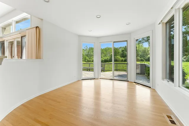 an empty room with a ceiling fan and a window