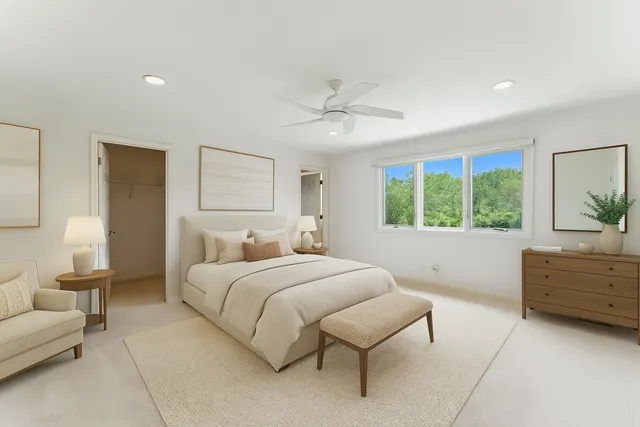 an empty room with windows and ceiling fan