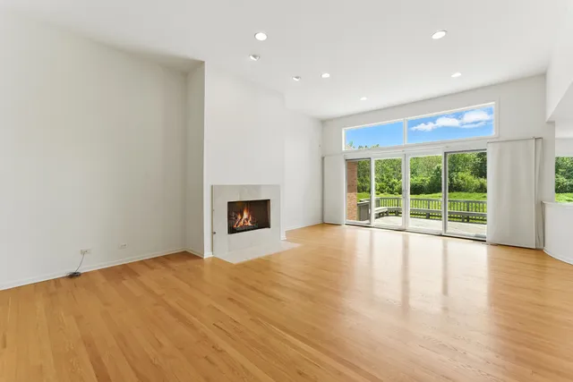 a living room with furniture fireplace and a large window