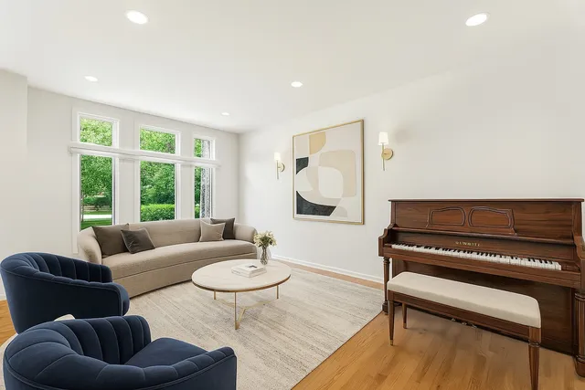 a dining room with furniture wooden floor a rug and a chandelier