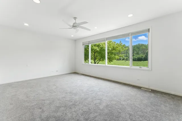 a spacious bedroom with a bed and a couch