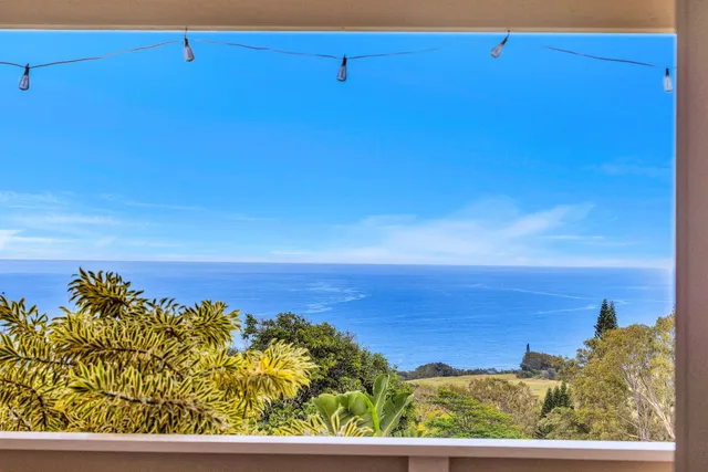 a view of a balcony with couch and wooden floor