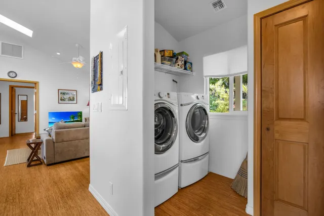 a kitchen with a stove a sink a kitchen island with a dining table and chairs