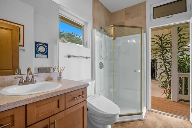 a view of a dining room with furniture a kitchen and chandelier