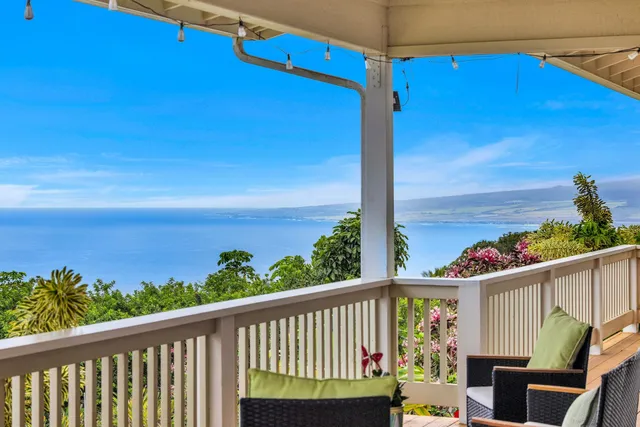 a view of a balcony with chair and wooden floor