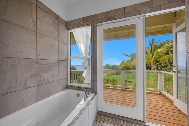 a bathroom with a bath tub and shower