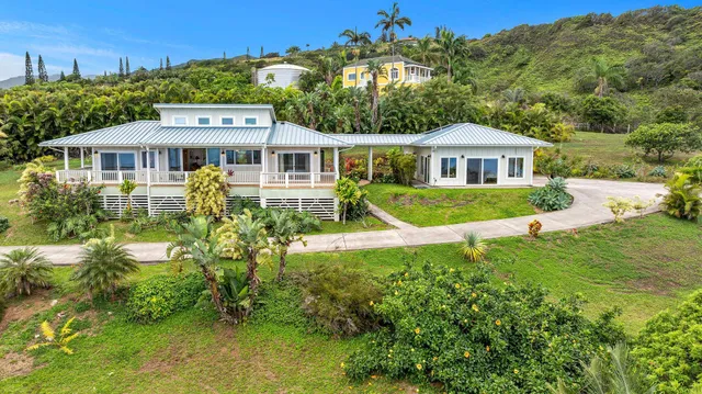 an aerial view of residential houses with outdoor space and trees