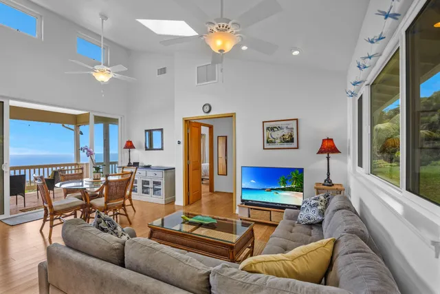 a living room with furniture kitchen and a chandelier