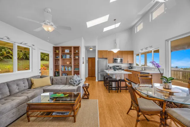 a living room with furniture and kitchen view