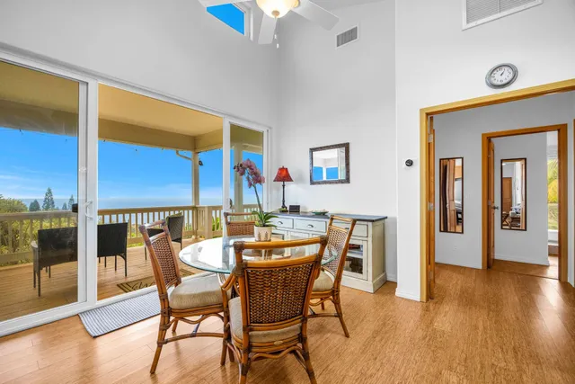 a dining room with furniture and wooden floor