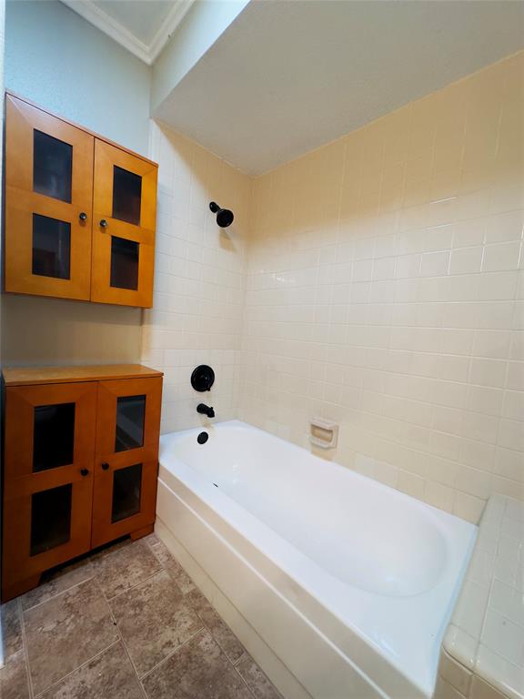 3929 St Christopher Lane Dallas, TX 75287 - Photo 12 of 22 a bathroom with a bathtub and a window