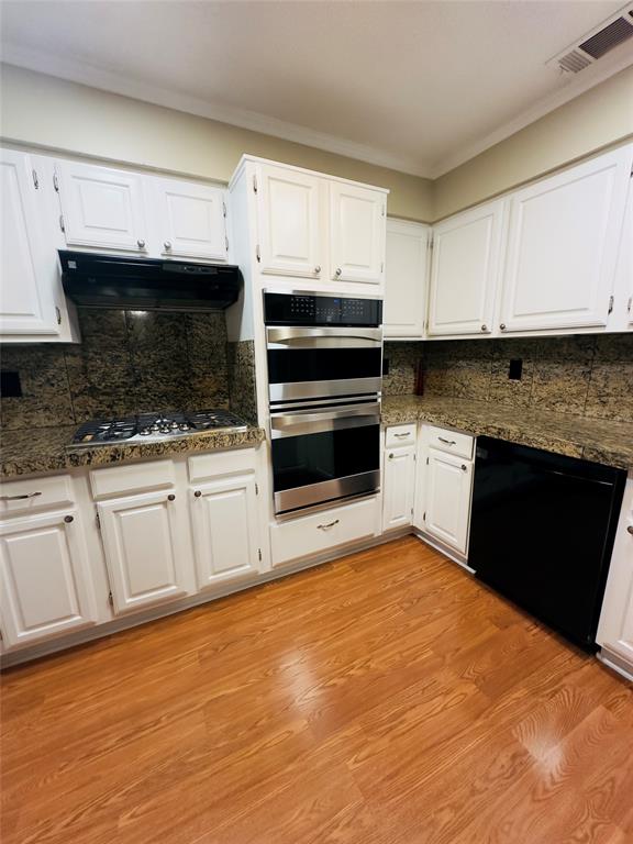 3929 St Christopher Lane Dallas, TX 75287 - Photo 18 of 22 a kitchen with granite countertop a stove microwave and sink