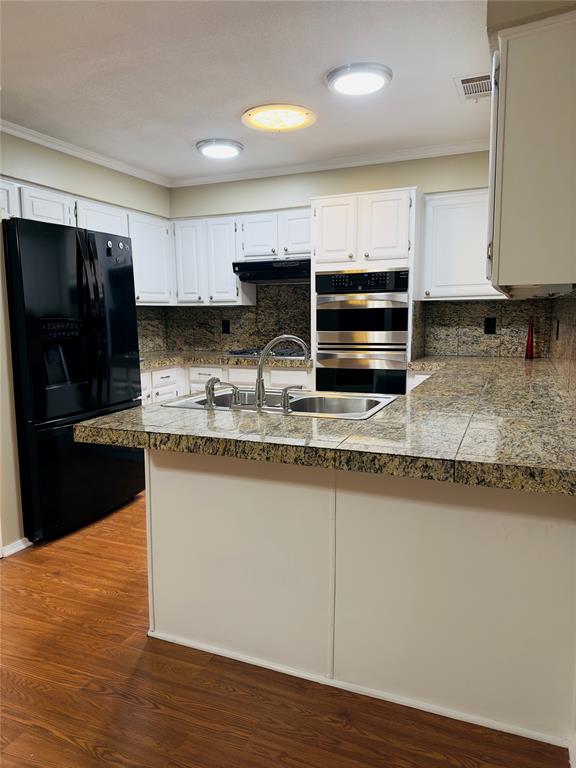 3929 St Christopher Lane Dallas, TX 75287 - Photo 20 of 22 a kitchen with stainless steel appliances granite countertop a stove a sink and a refrigerator