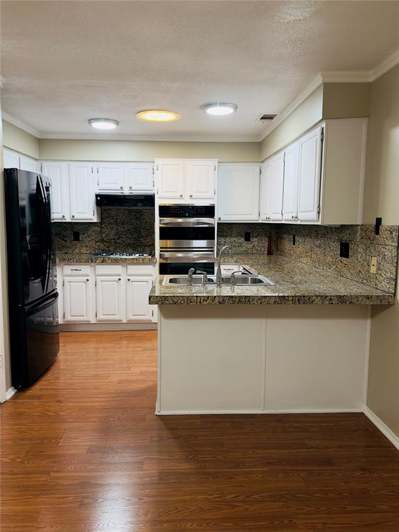 3929 St Christopher Lane Dallas, TX 75287 - Photo 21 of 22 a kitchen with stainless steel appliances granite countertop a stove a sink and a microwave