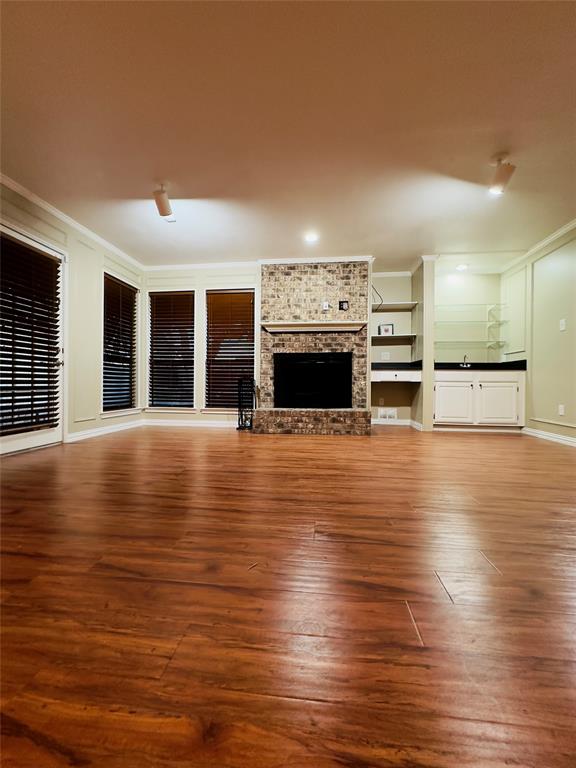 3929 St Christopher Lane Dallas, TX 75287 - Photo 4 of 22 a view of a living room with floor to ceiling window and kitchen view
