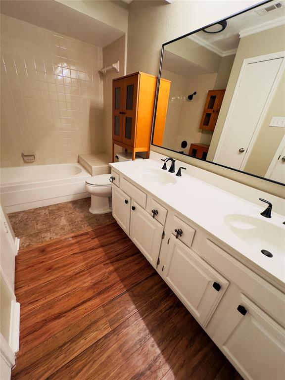 3929 St Christopher Lane Dallas, TX 75287 - Photo 9 of 22 a bathroom with a double vanity sink toilet and shower