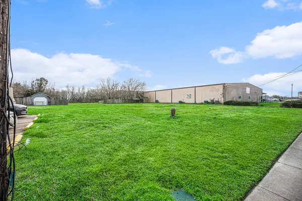 a view of an house with backyard space and balcony