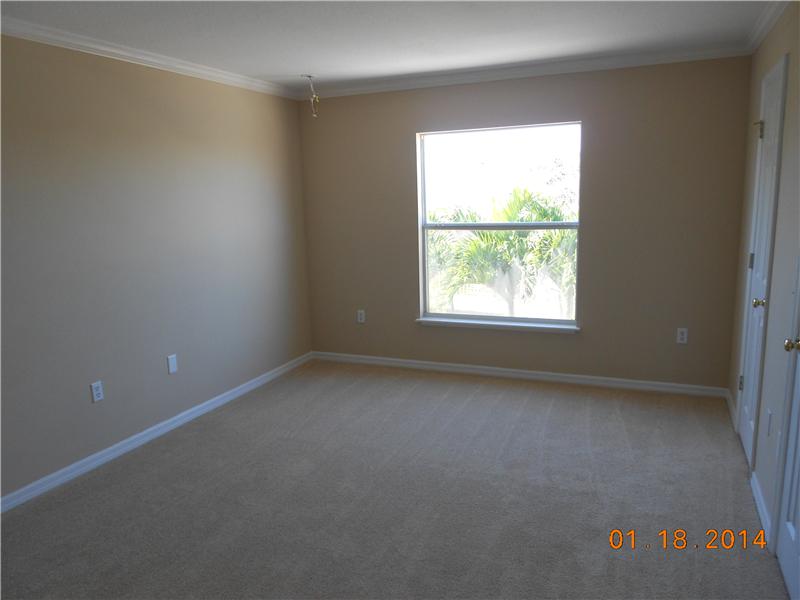 6044 Ridge Lake Circle Vero Beach, FL 32967 - Photo 13 of 14 an empty room with a window