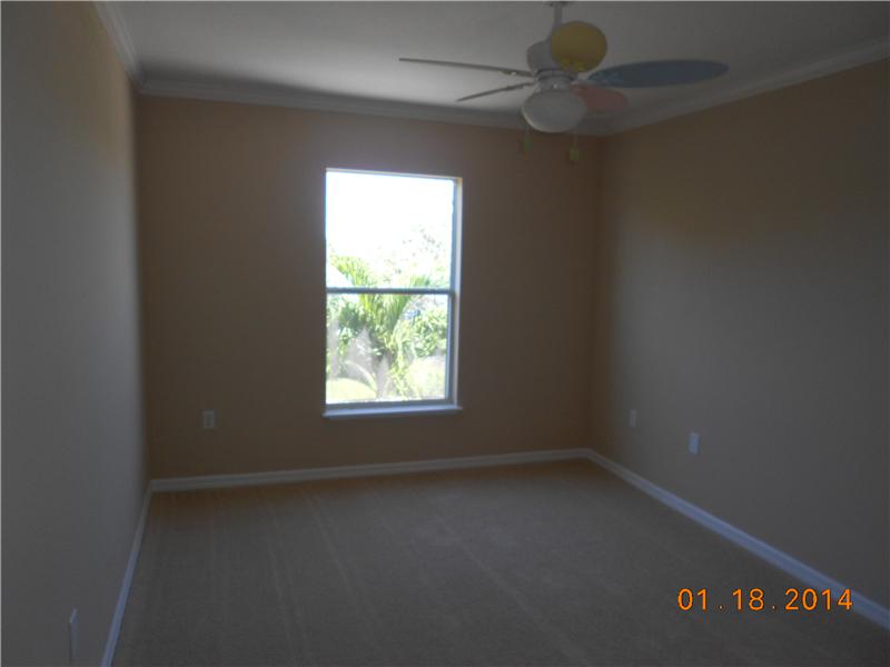 6044 Ridge Lake Circle Vero Beach, FL 32967 - Photo 14 of 14 an empty room with a window