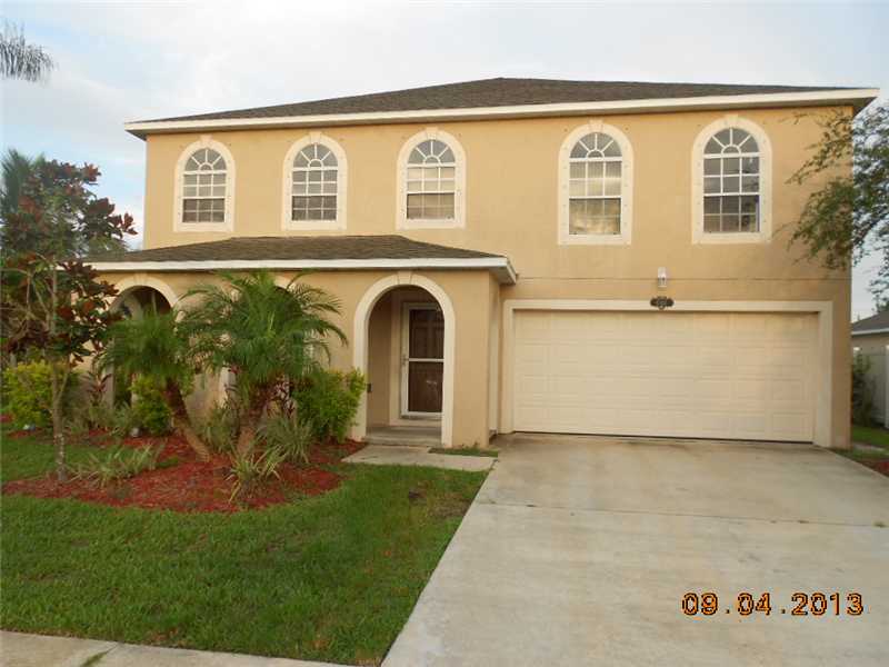 6044 Ridge Lake Circle Vero Beach, FL 32967 - Photo 2 of 14 a front view of a house with garden