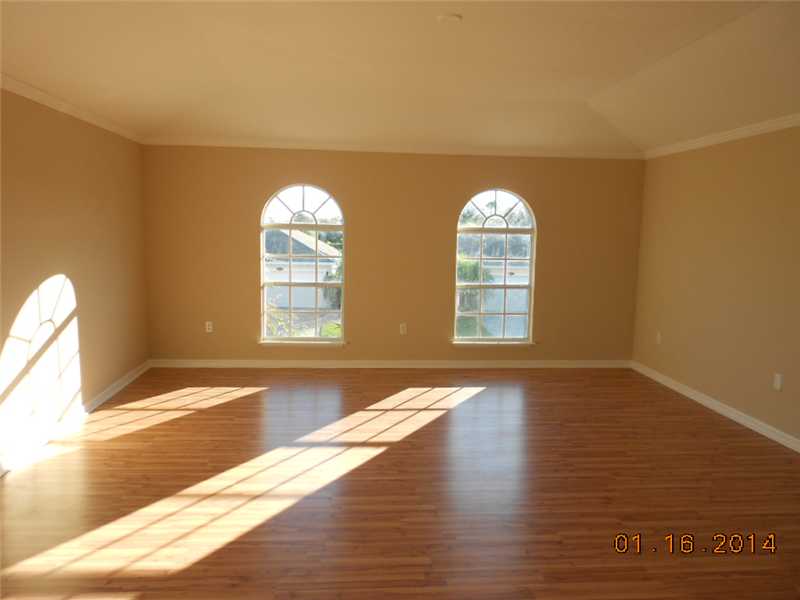 6044 Ridge Lake Circle Vero Beach, FL 32967 - Photo 5 of 14 a view of empty room with wooden floor and fan
