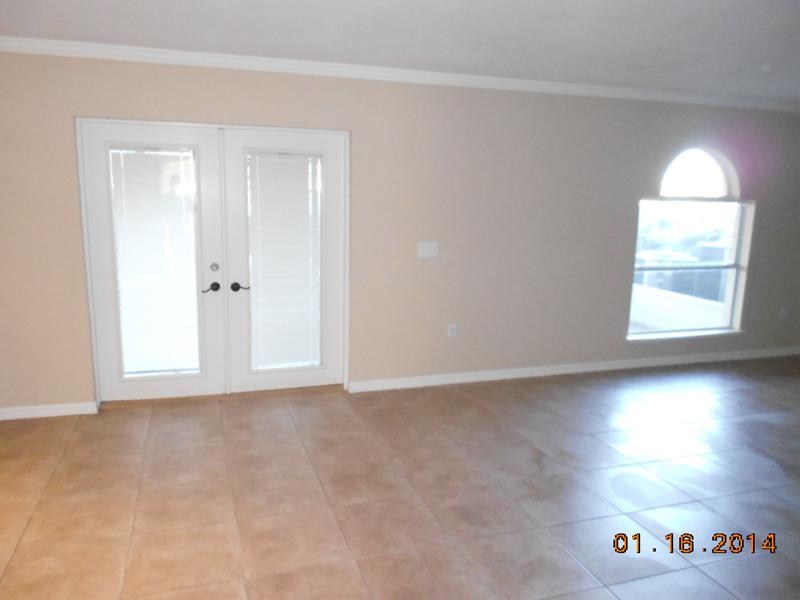 6044 Ridge Lake Circle Vero Beach, FL 32967 - Photo 8 of 14 an empty room with wooden floor and window