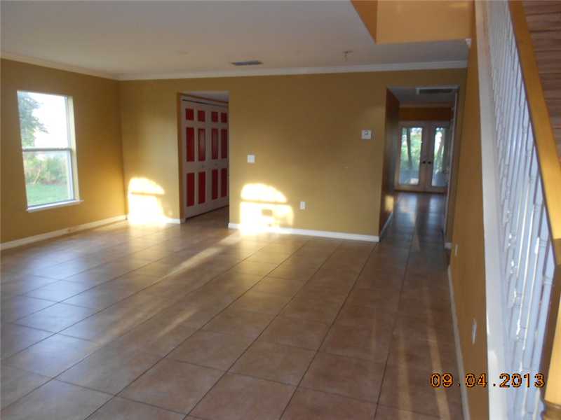 6044 Ridge Lake Circle Vero Beach, FL 32967 - Photo 9 of 14 a view of empty room with wooden floor and fan