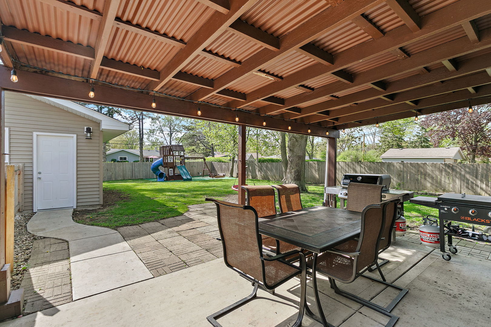 710 Olive Street Hoffman Estates, IL 60169 - Photo 22 of 30 a view of a patio with a table chairs and a backyard