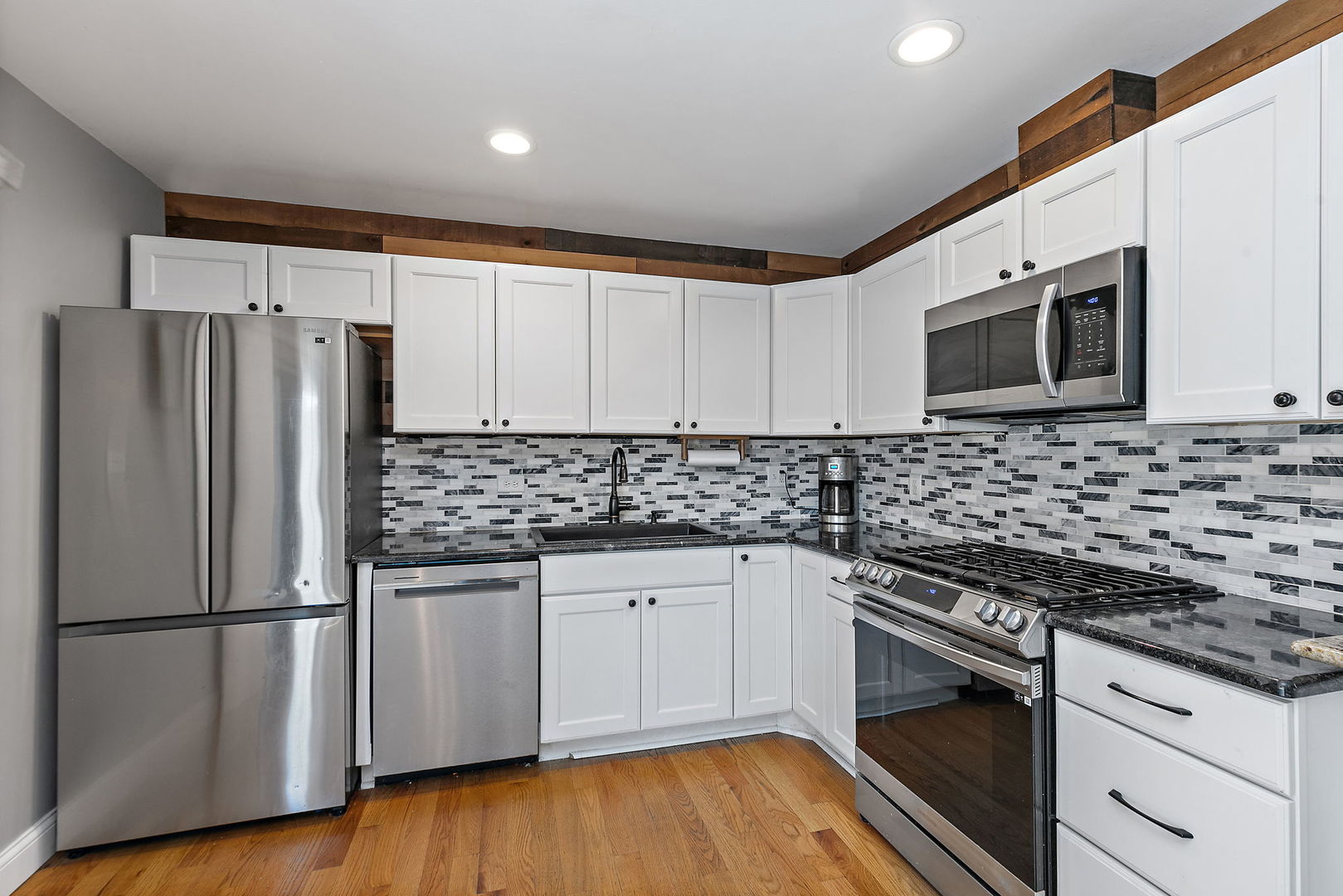710 Olive Street Hoffman Estates, IL 60169 - Photo 8 of 30 a kitchen with granite countertop a refrigerator and a stove top oven