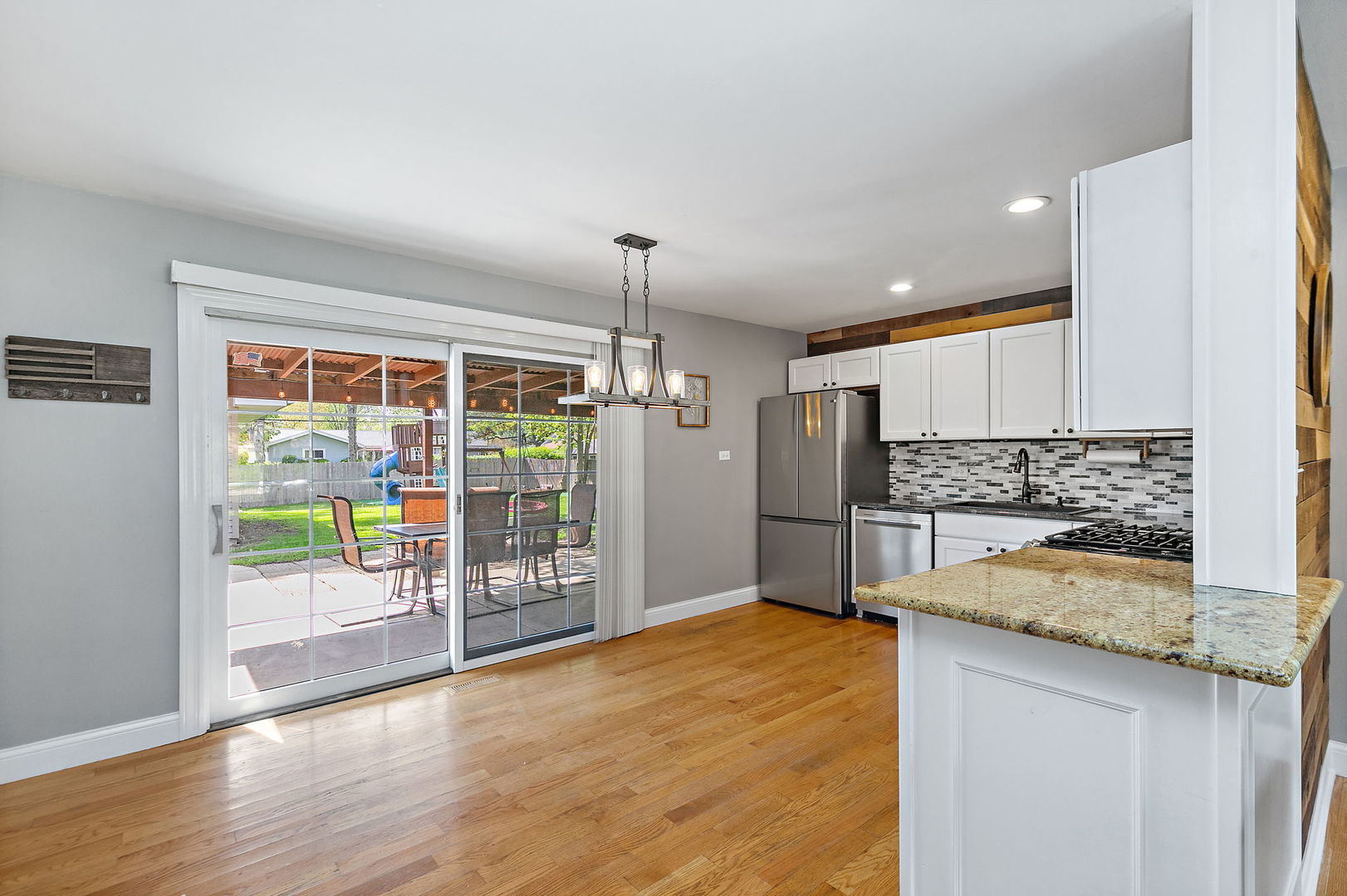 710 Olive Street Hoffman Estates, IL 60169 - Photo 9 of 30 a kitchen with stainless steel appliances wooden floor and a refrigerator