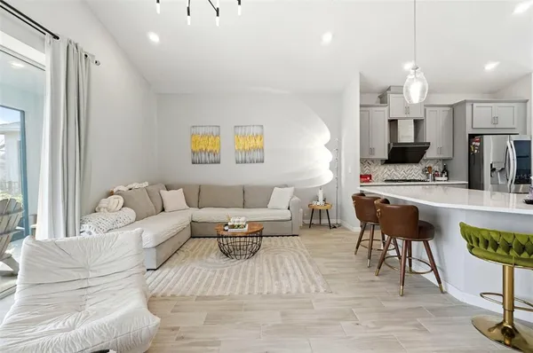 a living room with furniture and a chandelier