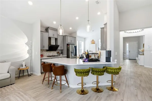 a living room with furniture and kitchen view