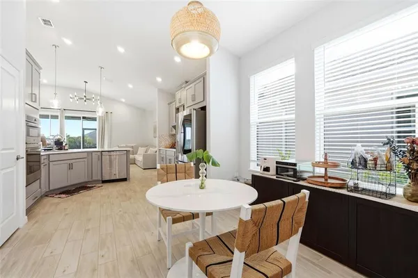 a kitchen with a table chairs stove and microwave