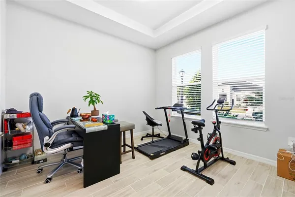 a view of a workspace with furniture and a window