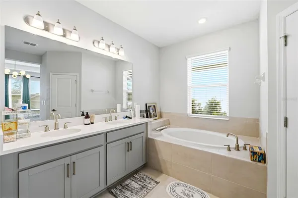 a spacious bathroom with a double vanity sink mirror double and bathtub
