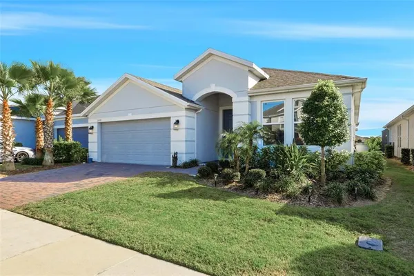 a front view of a house with a yard and garage