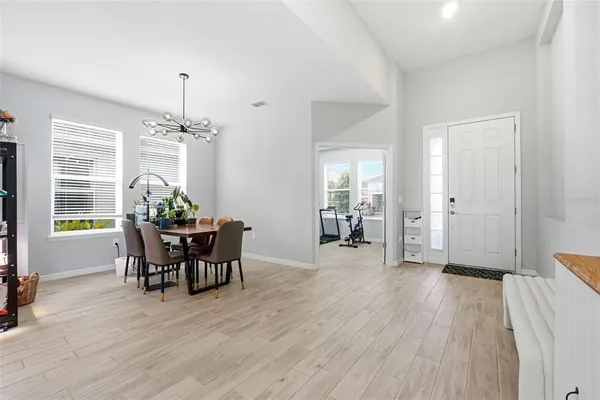 a view of a dining room with furniture and wooden floor
