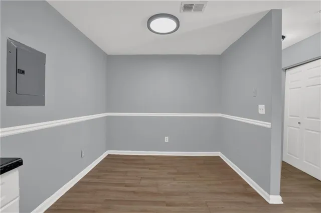 a view of an empty room with wooden floor