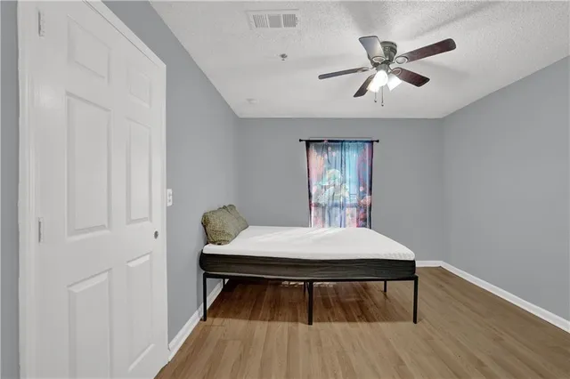 a workspace with wooden floor and a ceiling fan