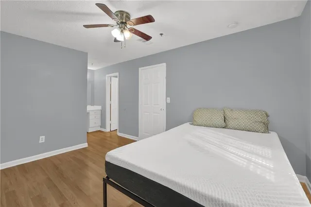 a view of a hallway with wooden floor and a sink
