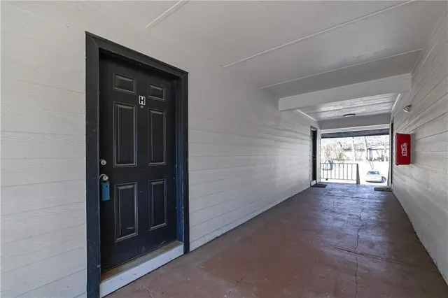 an empty room with windows and closet