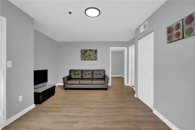 a bedroom with furniture and wooden floor